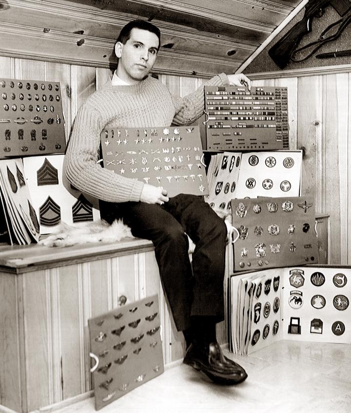 Fred sitting with his insignia collection of patches and medals